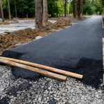 Laying asphalt on a pedestrian path in a city park, landscaping